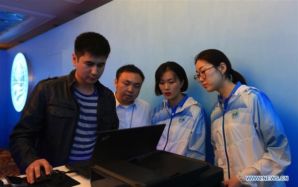 Volunteers Work at Registration Center for 18th SCO Summit in Qingdao