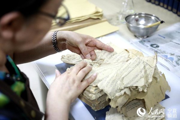 Ancient Books Restorer Committed to Protecting Treasures of Civilization