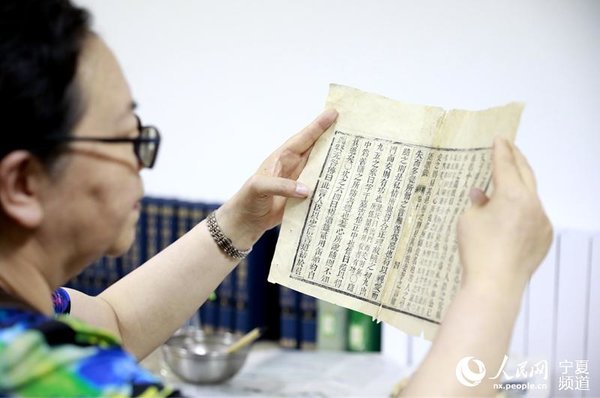 Ancient Books Restorer Committed to Protecting Treasures of Civilization