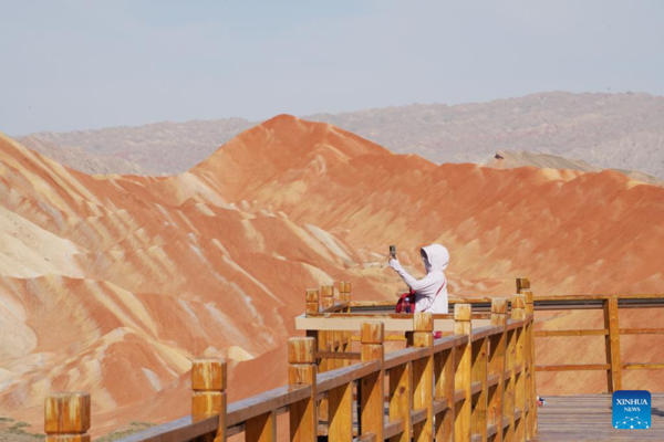 Danxia National Geological Park in NW China Attracts Tourists with Unique Landscape